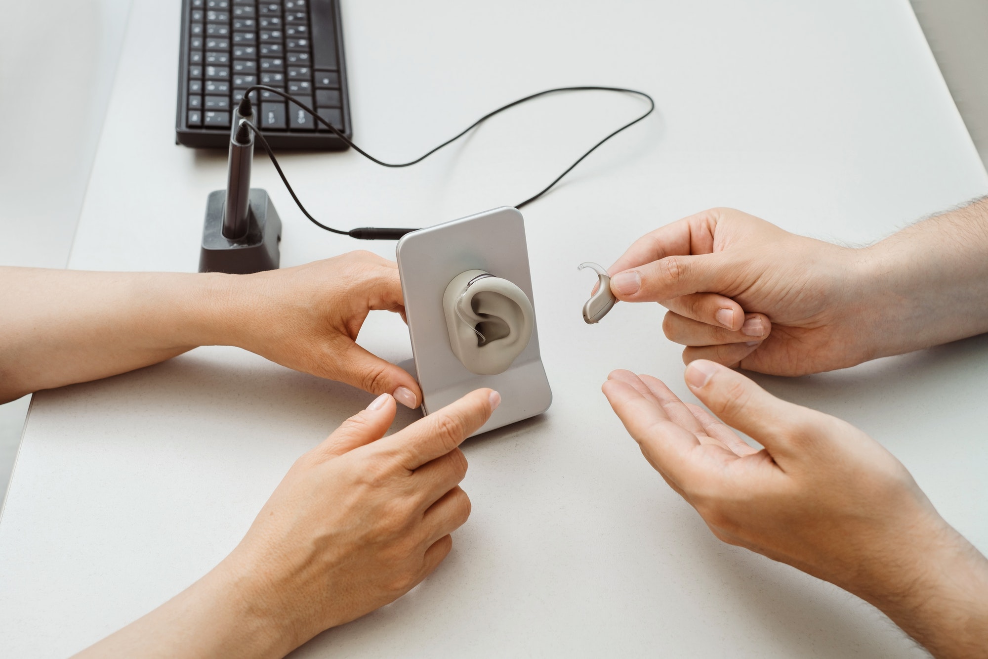 Modern hearing aid in hands